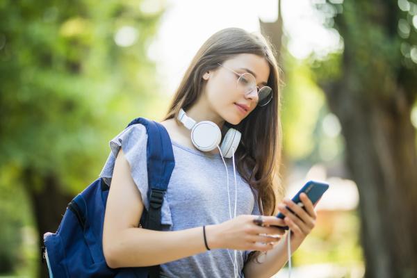 Photo of student logging service hours on her phone using Track it Forward and Clever