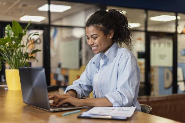 Photo of a young woman on a laptop using Google single sign-on integration with Track it Forward.