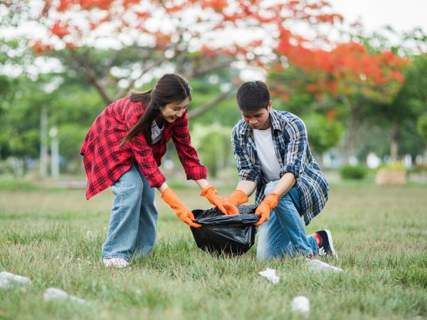 Photo of two students volunteering at a park cleanup event. Students can use Track it Forward and the new Veracross SIS integration to easily log service hours and upload verifications!